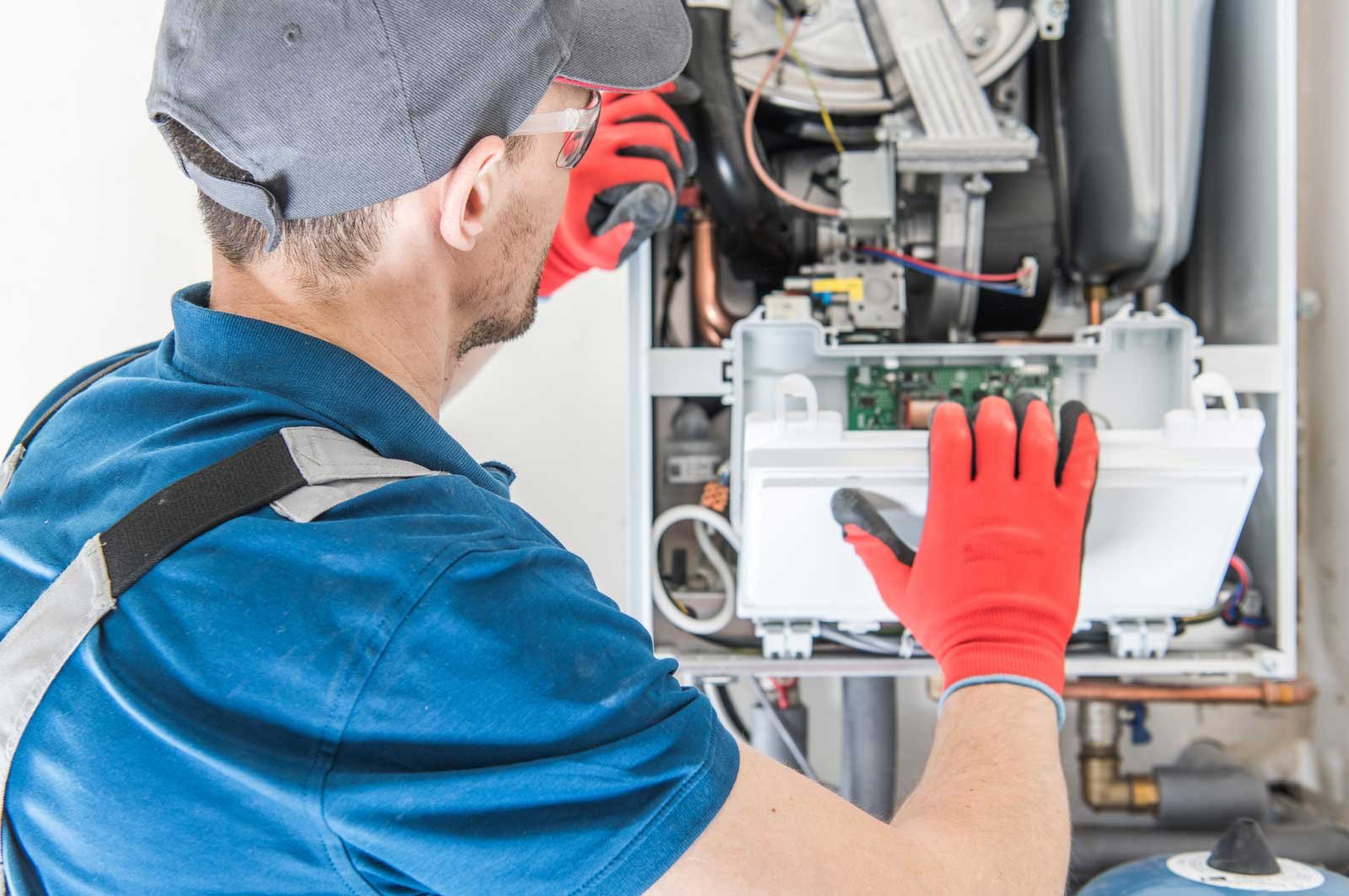 Technician performing fall furnace maintenance in Los Angeles home