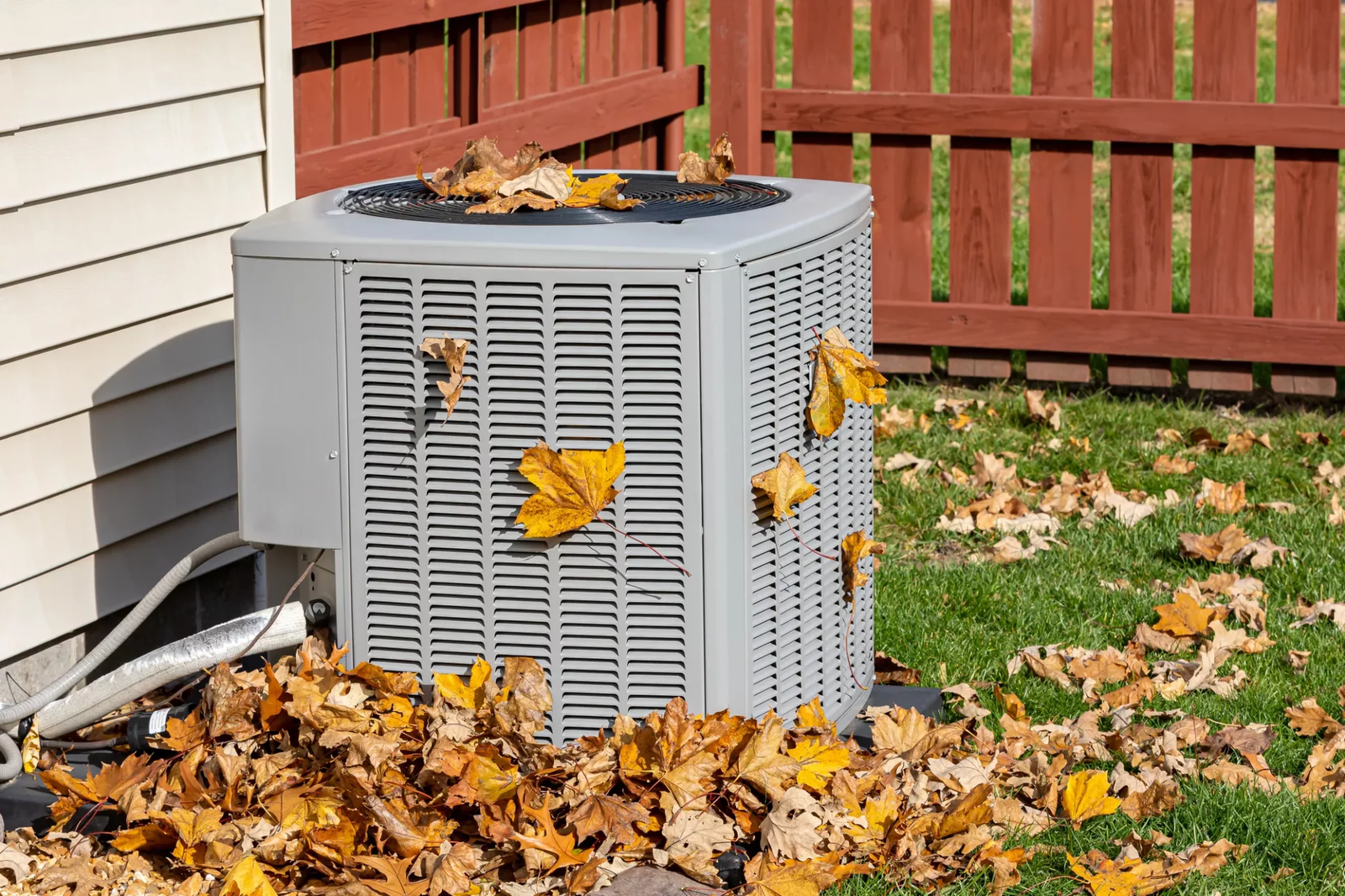 Professional HVAC technician installing a furnace system during fall