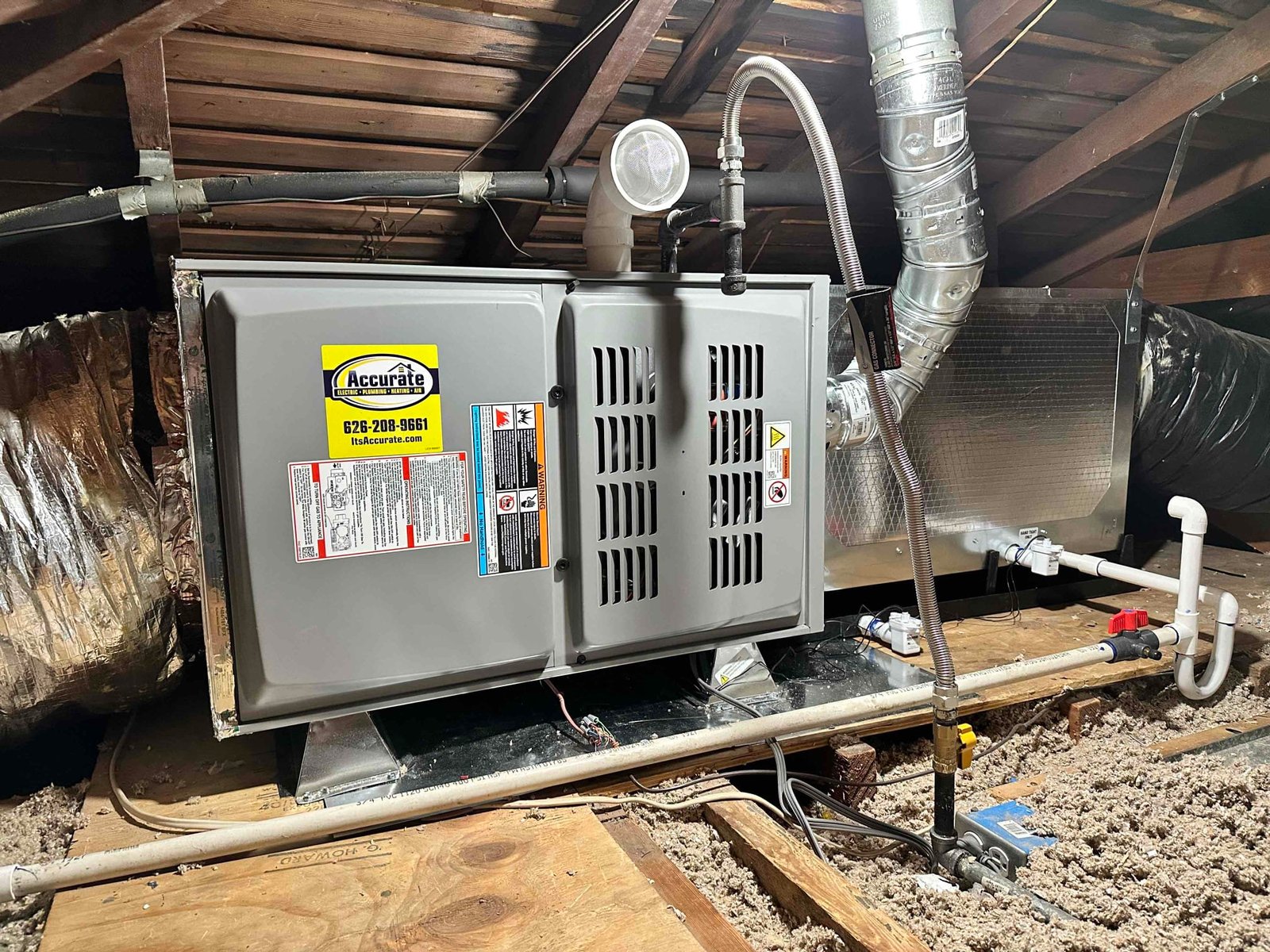 Family decorating a home with technician checking HVAC system