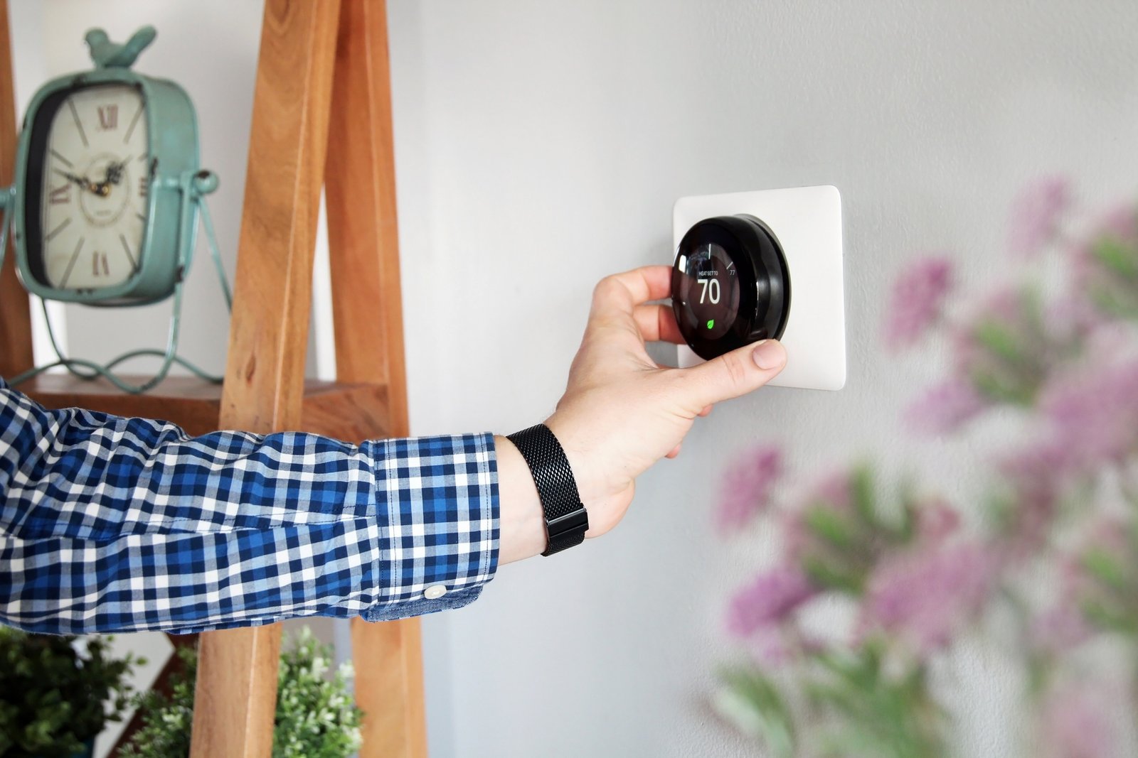 Programmable smart thermostat mounted on wall in modern home, showing eco mode