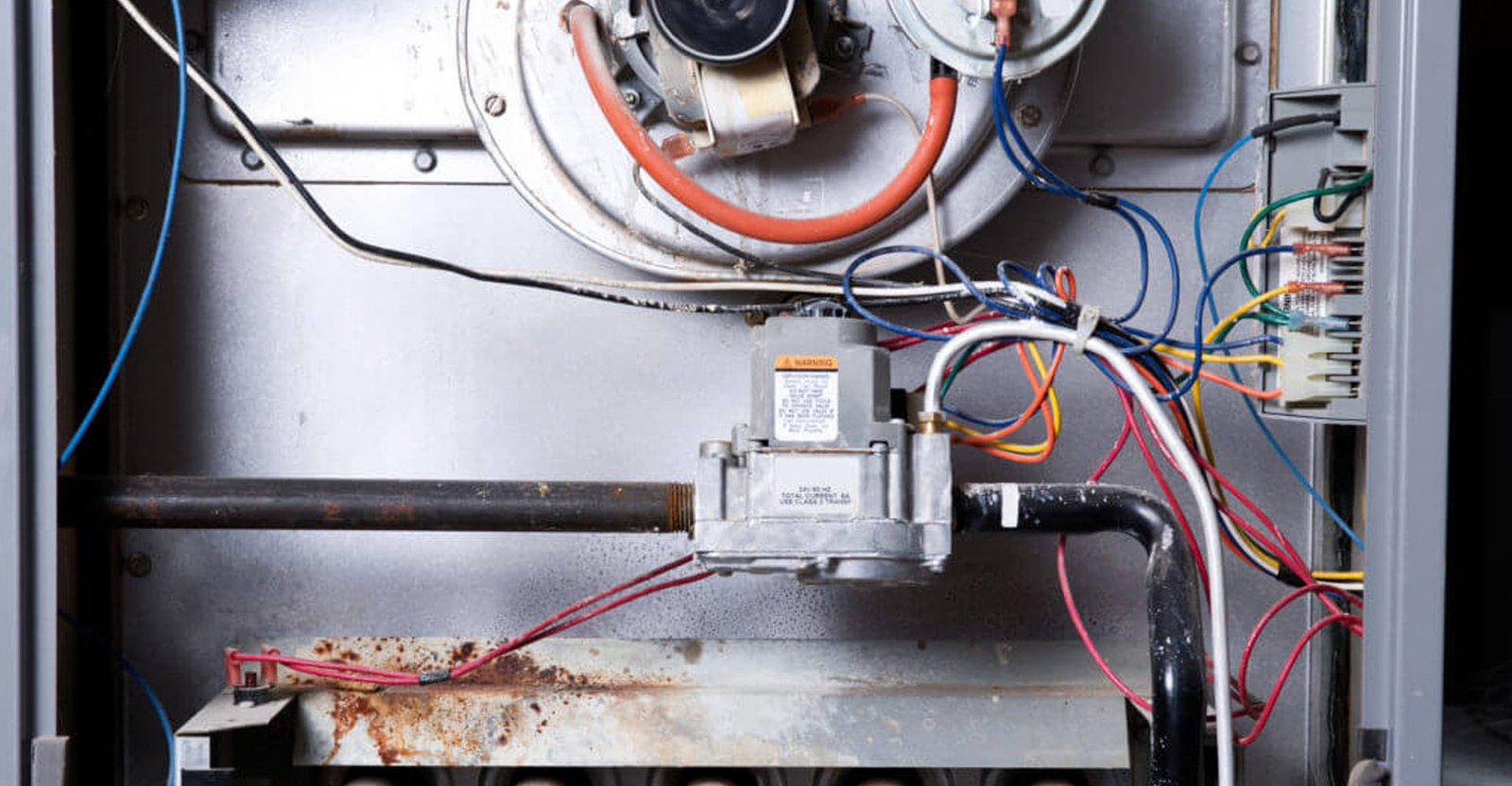 Technician checking furnace for cold air issue in California home