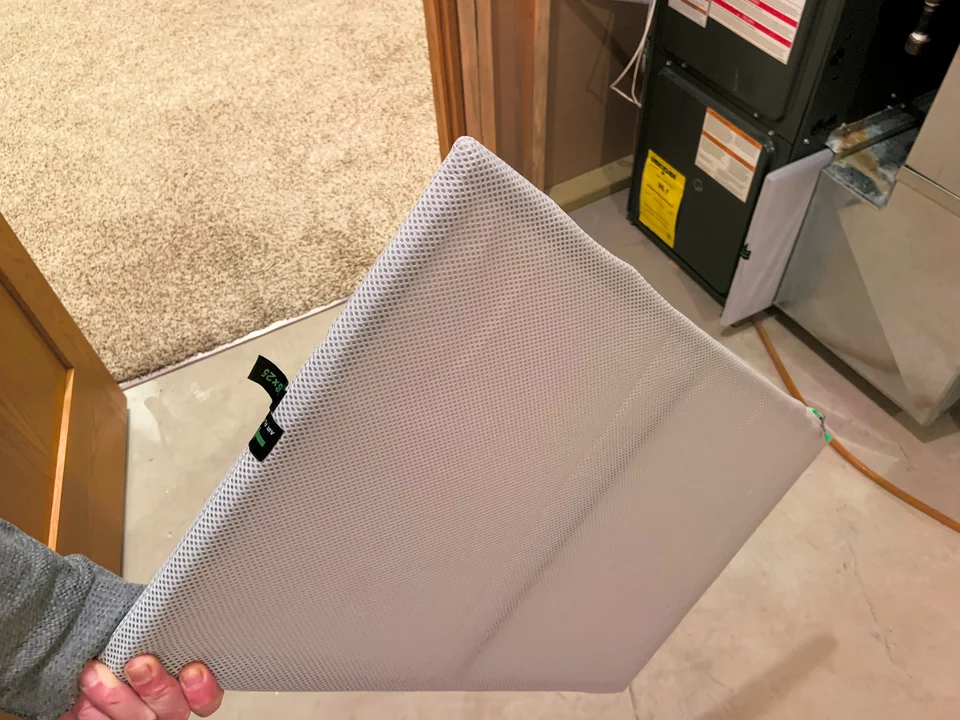 HVAC air filter being changed out in someone's utility closet