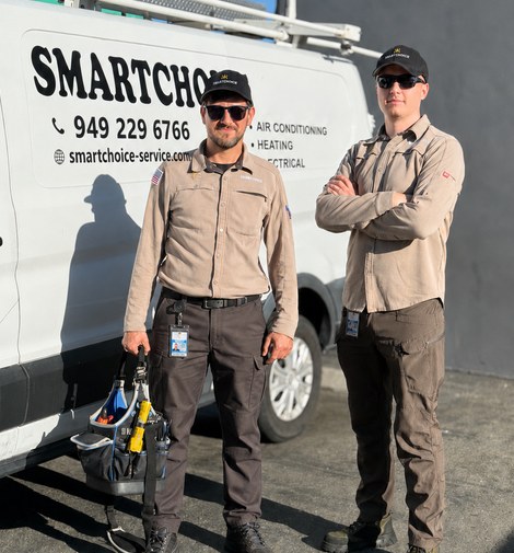 The Smartchoice owners in uniform in front of a company service van